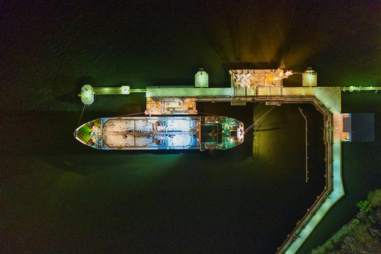 a boat that is sitting in the water, by Daniel Lieske, pexels contest winner, process art, aerial photo night vision, shipping docks, on the deck of a ship, panoramic shot