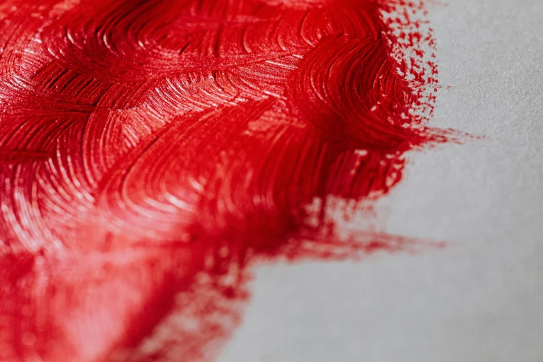 a close up of red paint on a piece of paper, a photorealistic painting, trending on pexels, silver red, vibrant threads, detailed product image, vibrant red