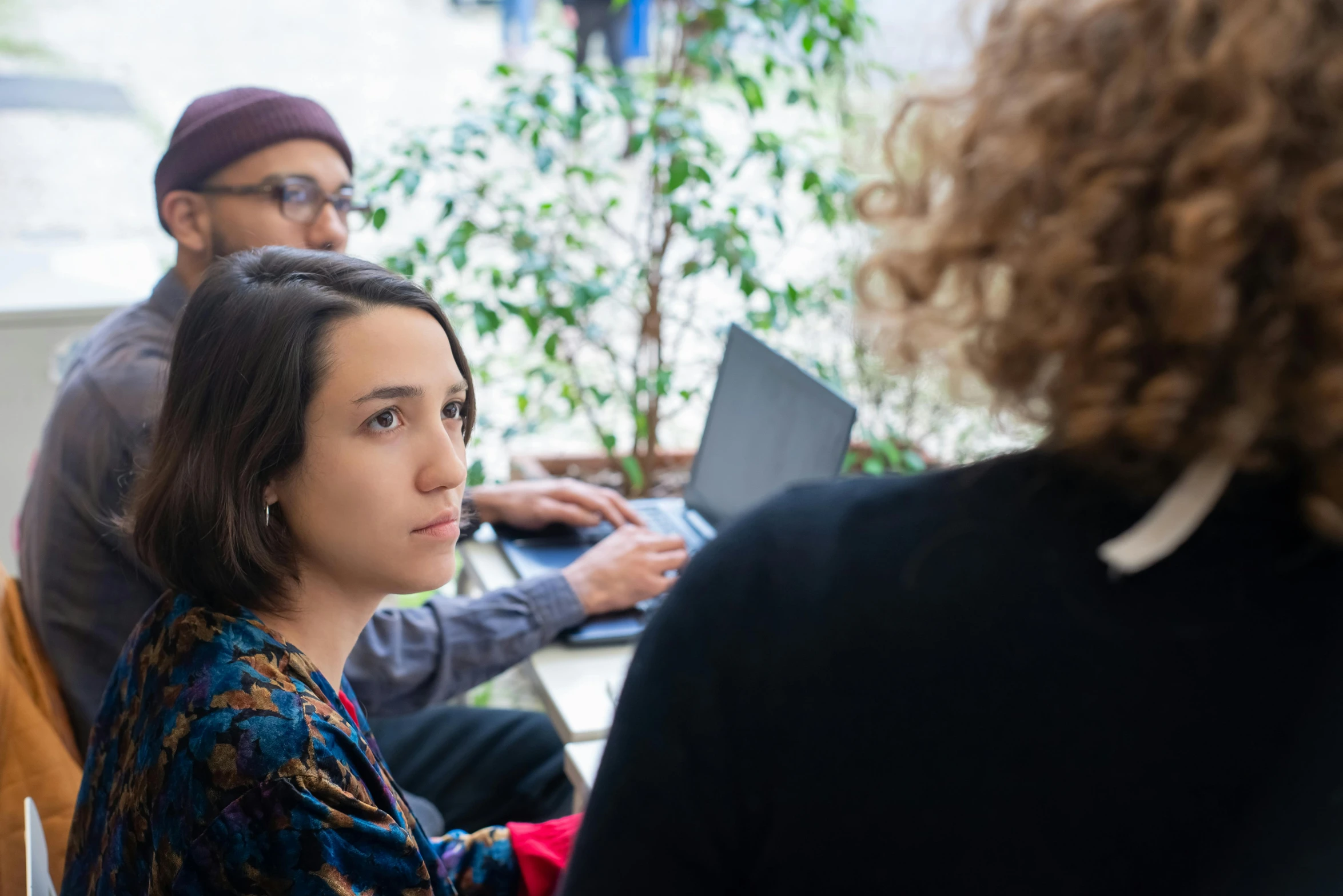 a group of people sitting around a table with laptops, pexels contest winner, arbeitsrat für kunst, woman's face looking off camera, environmental shot, rebecca sugar, profile image