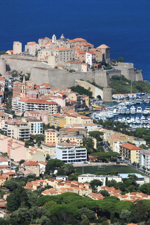 a city sitting on top of a hill next to the ocean, french village exterior, slide show, highlights