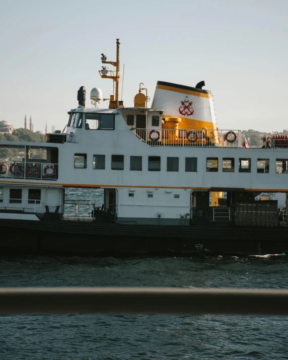 a large white boat sitting on top of a body of water, by Attila Meszlenyi, istanbul, lgbtq, thumbnail, low quality photo