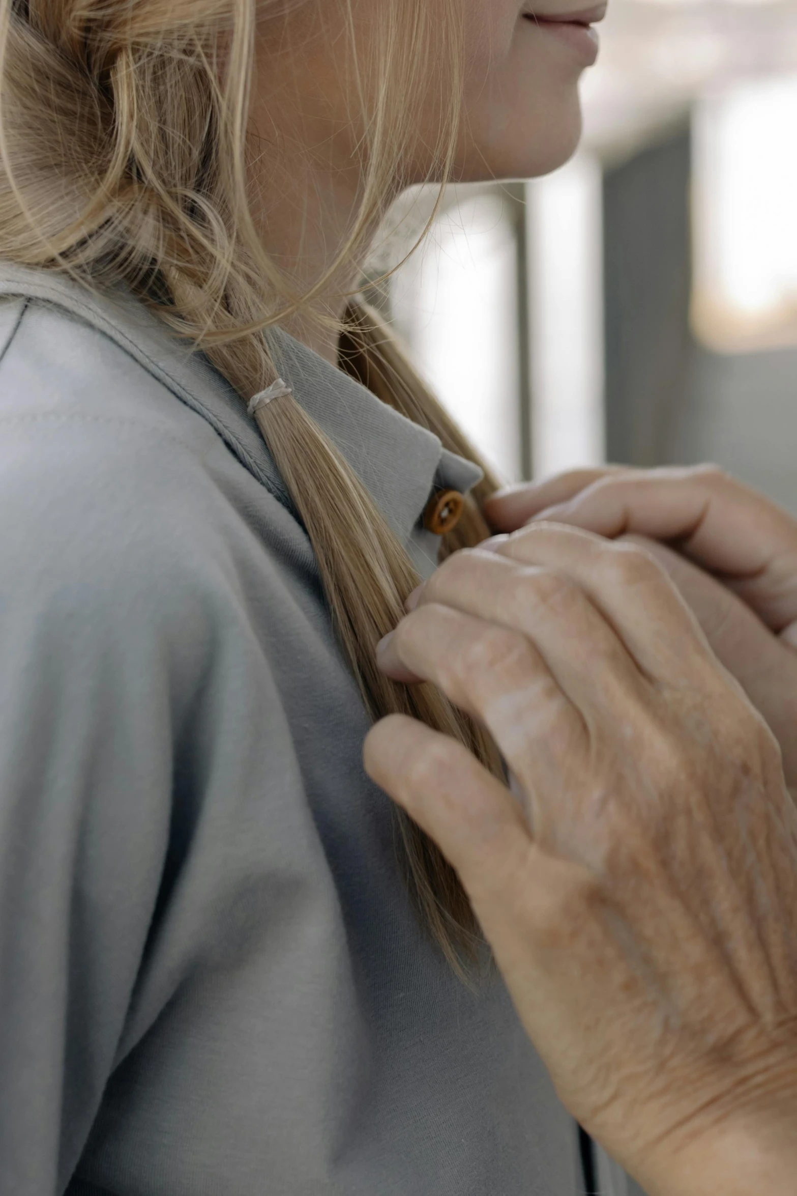 a woman putting a tie on another woman's neck, trending on pexels, hyperrealism, still from nature documentary, long blond braided hair, wearing polo shirt, worksafe. cinematic
