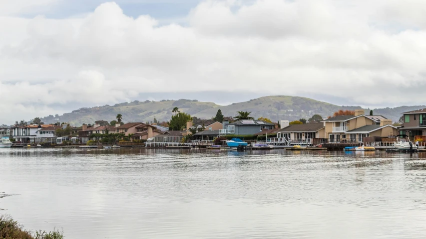 a body of water filled with lots of boats, cupertino, on a cloudy day, waterfront houses, lachlan bailey