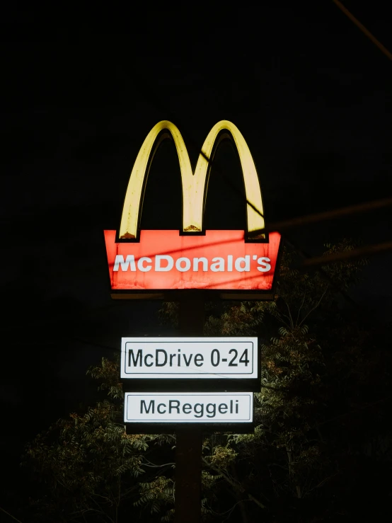 a mcdonald's drive thru sign lit up at night, an album cover, pexels, photorealism, trending on r/streetwear, 2 5 6 x 2 5 6 pixels, the merge, macguire is a tall