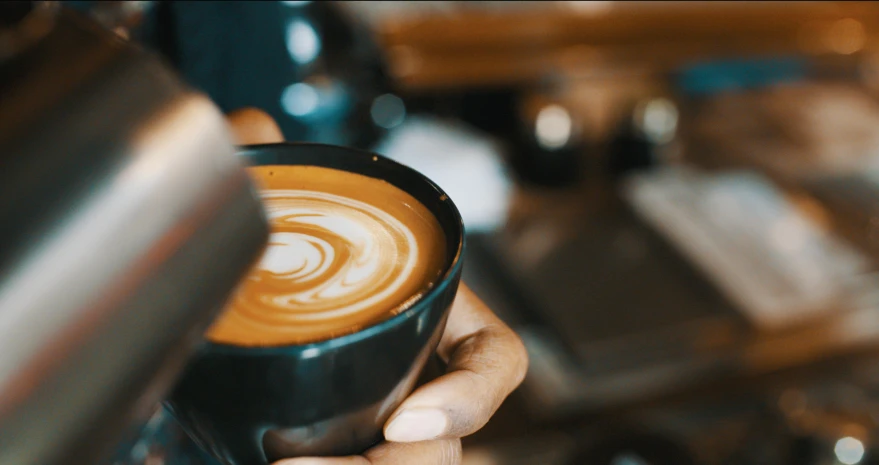 a close up of a person holding a cup of coffee, pouring techniques, mesmerising, avatar image, aussie baristas