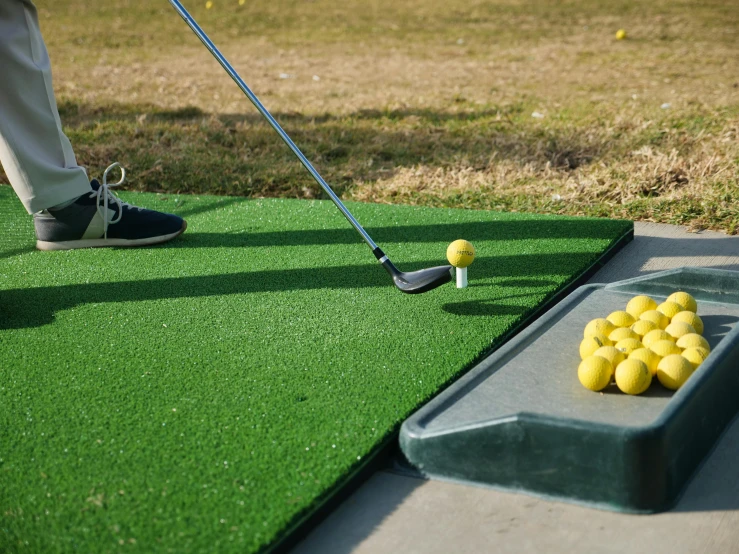 a man about to hit a golf ball on a putting green, soft surfaces, full metal overlay, bunkers, easy to use