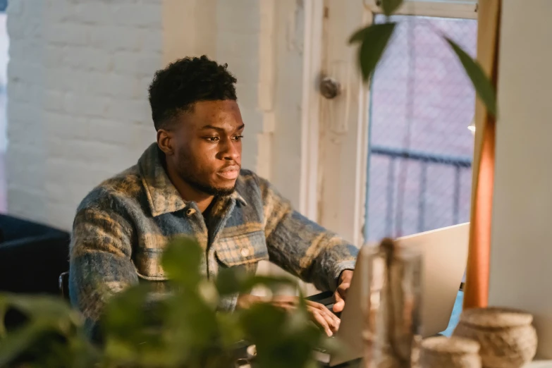 a man sitting in front of a laptop computer, by Carey Morris, pexels contest winner, renaissance, jaylen brown, they are very serious, early in the morning, avatar image