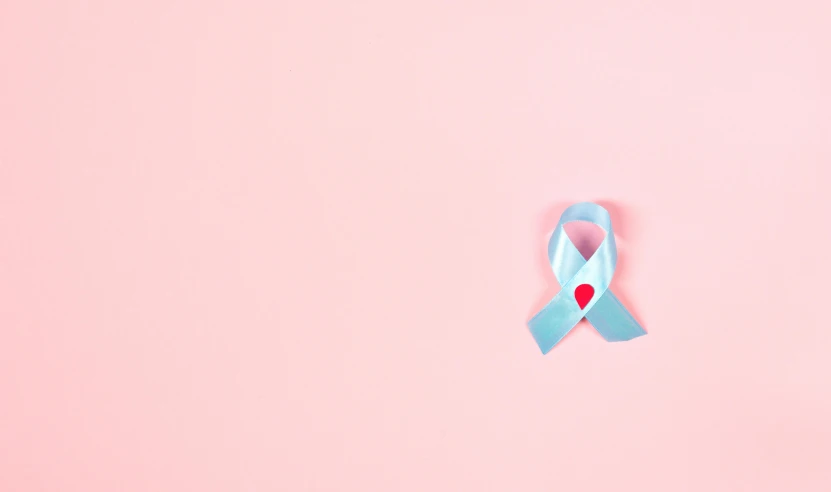 a blue ribbon with a red heart on a pink background, by Emma Andijewska, pexels contest winner, tumors, light blue skin, background image, nursing