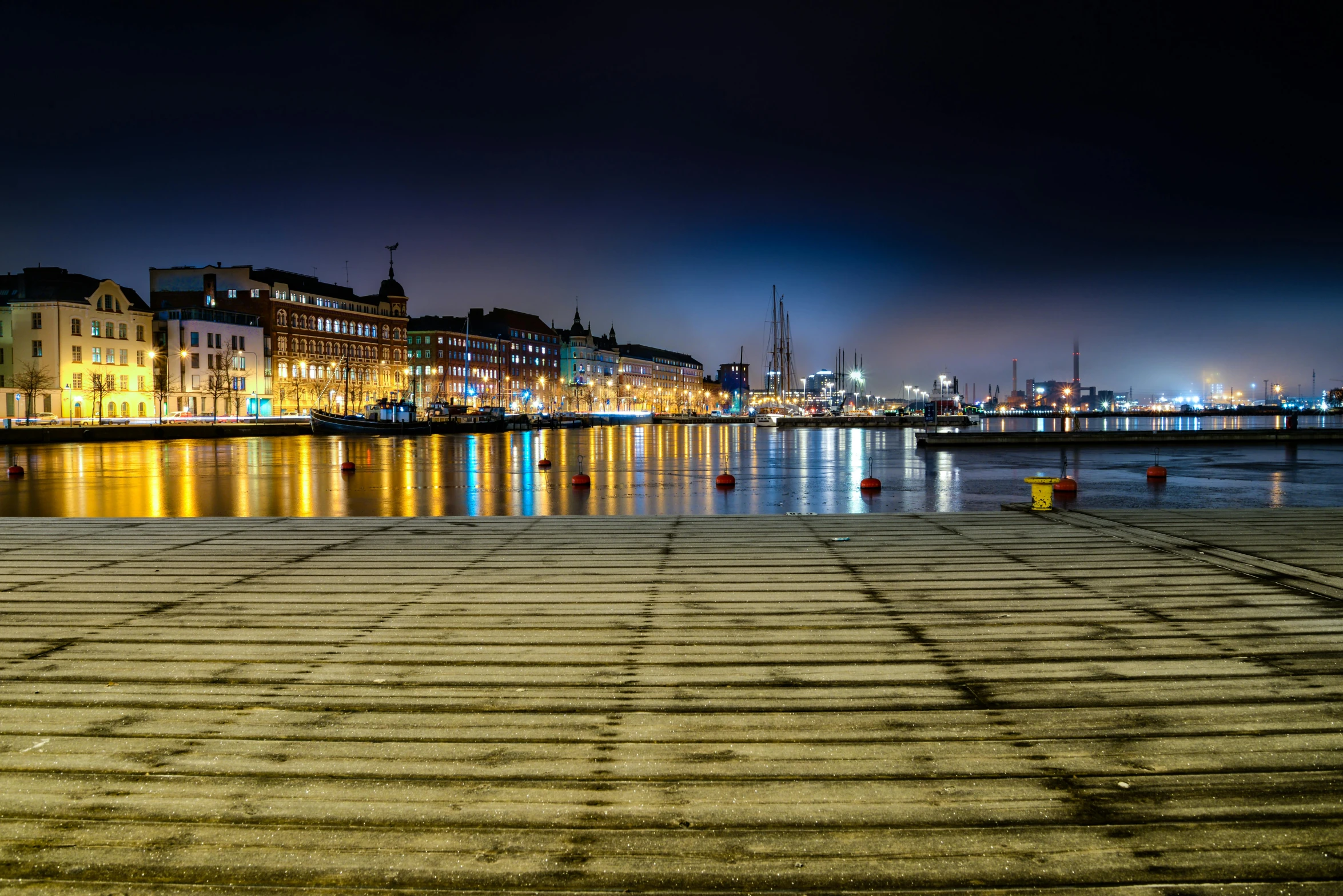 a large body of water next to a city at night, by Sebastian Spreng, pexels contest winner, denmark, square, boardwalk, port scene background