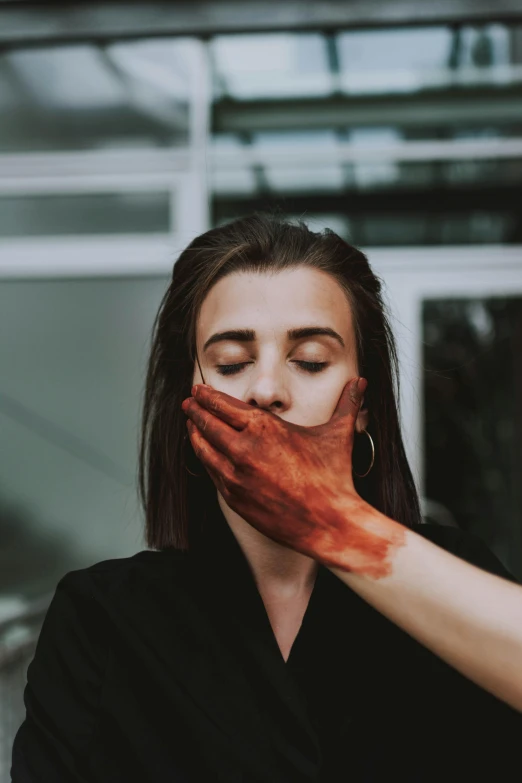 a woman putting makeup on another woman's face, a picture, inspired by Elsa Bleda, pexels contest winner, antipodeans, covered in ketchup, his hands buried in his face, wearing a brown, with disturbing