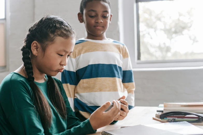 a couple of kids that are sitting at a table, pexels contest winner, mobile learning app prototype, essence, writing on a clipboard, 1 4 5 0