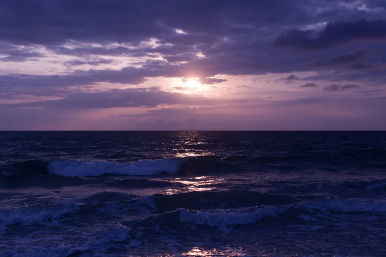 the sun is setting over the ocean on a cloudy day, a picture, unsplash, romanticism, purple bioluminescence, album, visable sounds waves, 8k octan photo