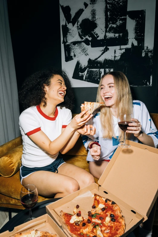 two women sitting on a couch eating pizza, pexels contest winner, renaissance, drinking beer and laughing, lana del rey and zoë kravitz, pizza box, sydney sweeney