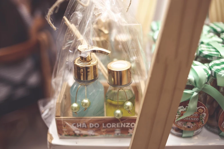 a couple of bottles of soap sitting on top of a shelf, a picture, by Dóra Keresztes, renaissance, golden accessories, brazilian, close-up, presents