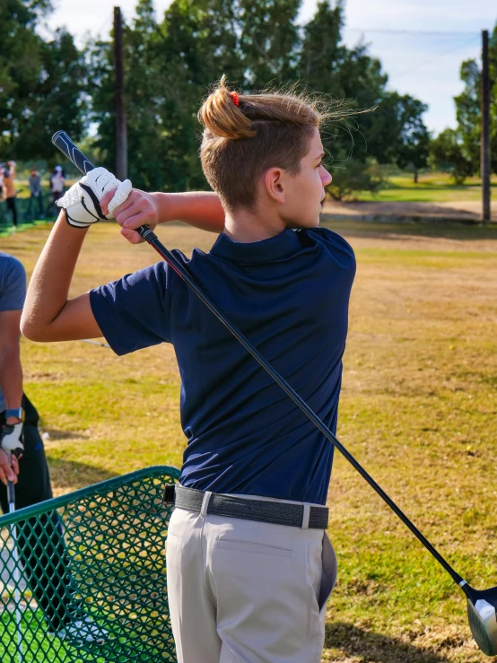 a man taking a swing at a golf ball, a portrait, by Arnie Swekel, unsplash, happening, teen boy, square, low quality photo, holding a crowbar