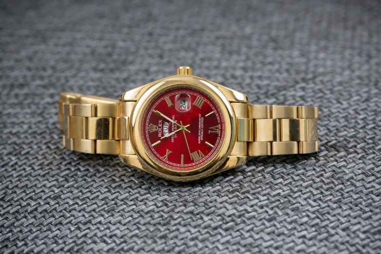 a gold wrist watch with a red dial, pexels contest winner, profile picture 1024px, reds)