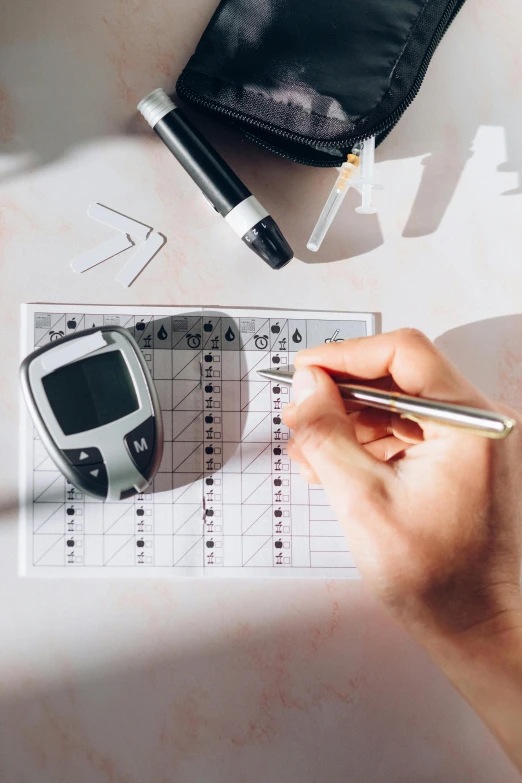 a person writing on a piece of paper next to a calculator, a picture, by Daniel Lieske, trending on pexels, analytical art, holding a syringe, diecut, flatlay, diagnostics