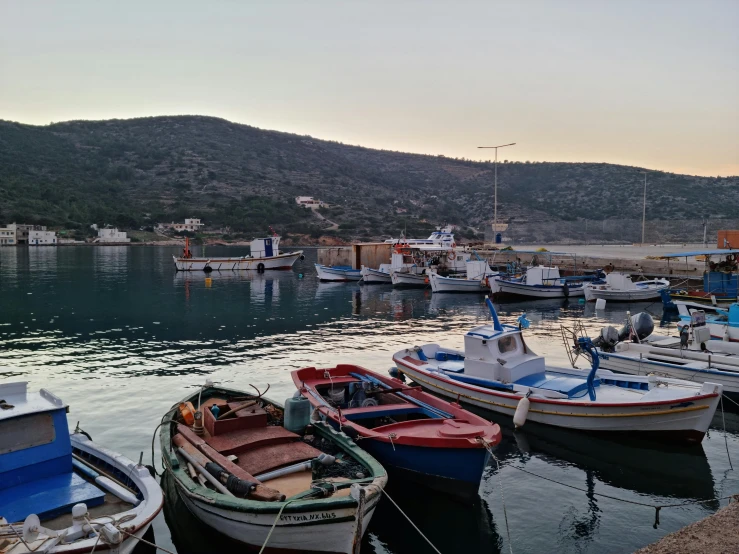 a number of small boats in a body of water, pexels contest winner, dau-al-set, greek setting, avatar image, small port village, early evening