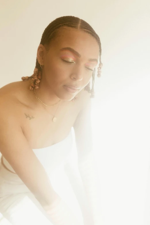 a woman sitting on top of a bed next to a window, by Dulah Marie Evans, unsplash, light and space, brown skin. light makeup, a glowing halo, milk bath photography, divine ray over her head