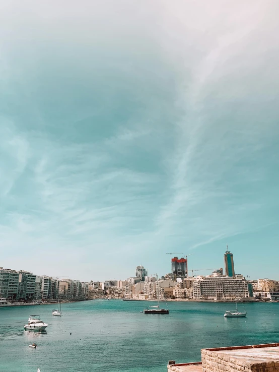 a large body of water with boats in it, by Julia Pishtar, pexels contest winner, alexandria\'s genesis, trending on vsco, sunny day with clear sky, skyline showing