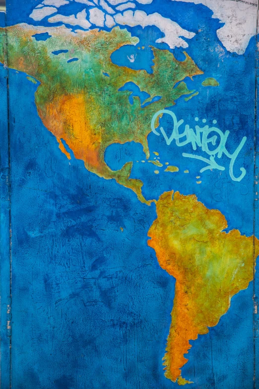 a wall with a map of the world painted on it, an album cover, by Anne Rigney, graffiti, oil on aged tin, blue, hispanic, close-up from above