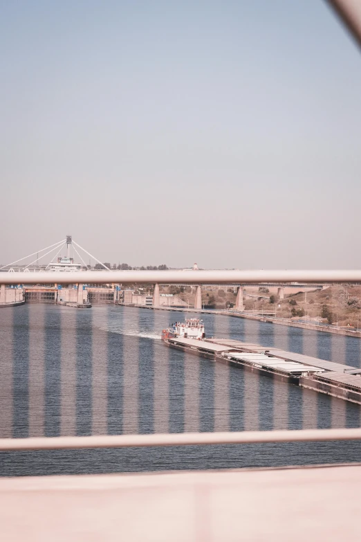 a body of water with a bridge in the background, a picture, happening, from egypt, monorail, poor quality, & a river