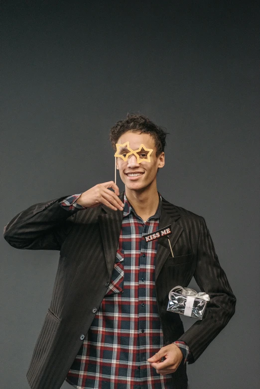 a man in a suit and sunglasses holding a camera, by Jacob Toorenvliet, holography, a man wearing golden mask, ashteroth, while smiling for a photograph, extremely long forehead