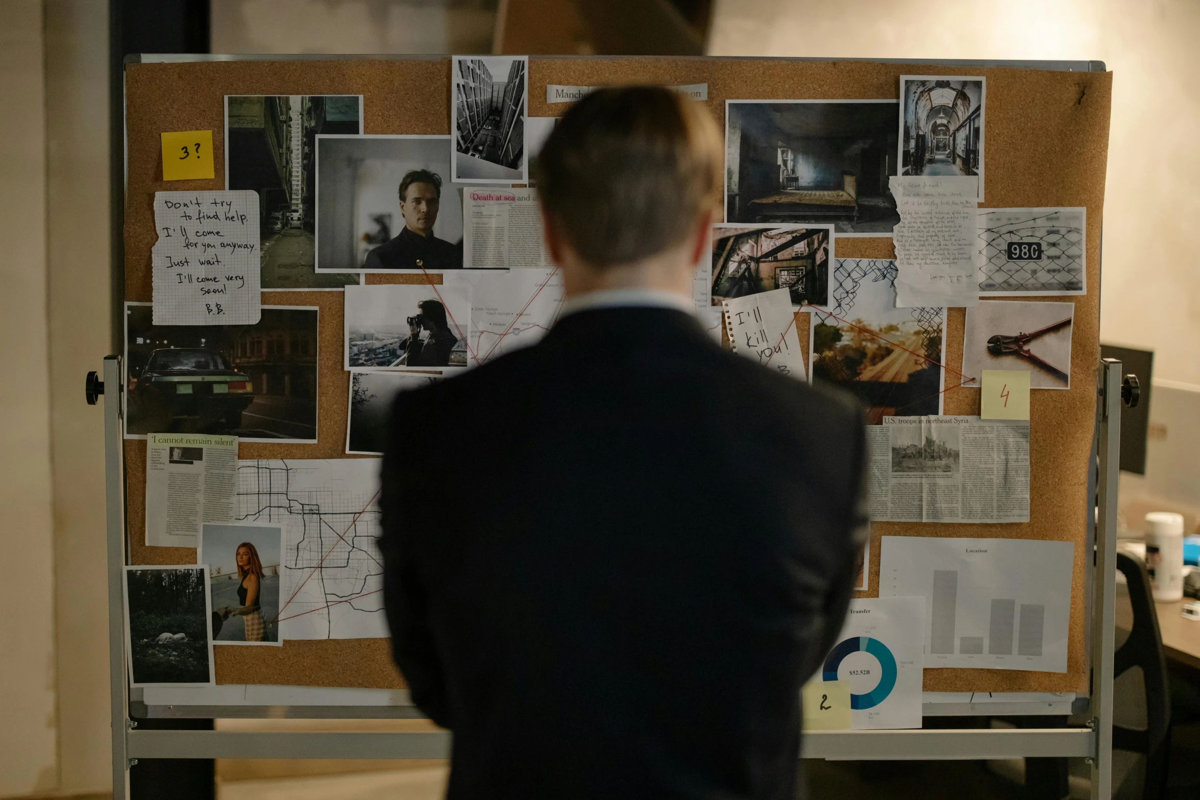 a man standing in front of a bulletin board, a picture, inspired by John Watson Gordon, pexels contest winner, serial art, production still, long shot from back, suits, investigation