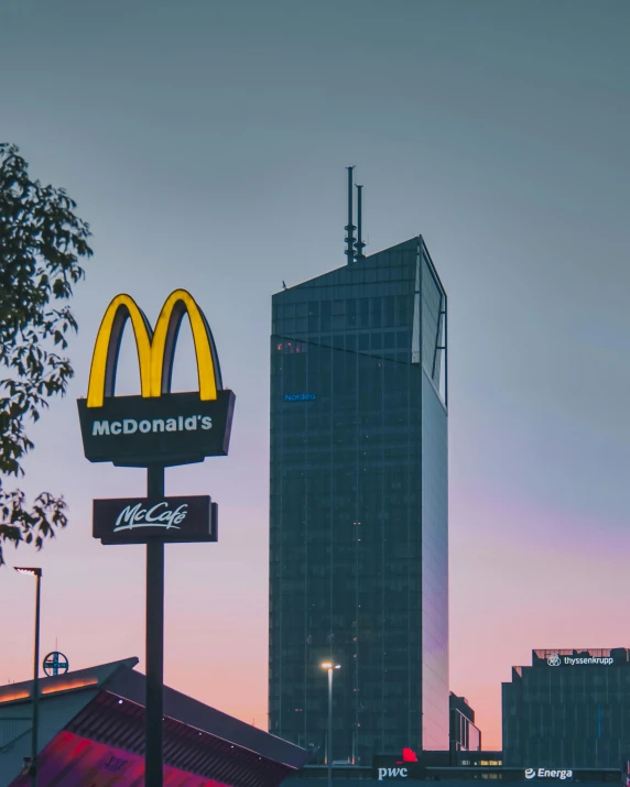 a mcdonald's sign in front of a tall building, trending on unsplash, magical realism, buenos aires, city buildings on top of trees, predawn, on a hot australian day