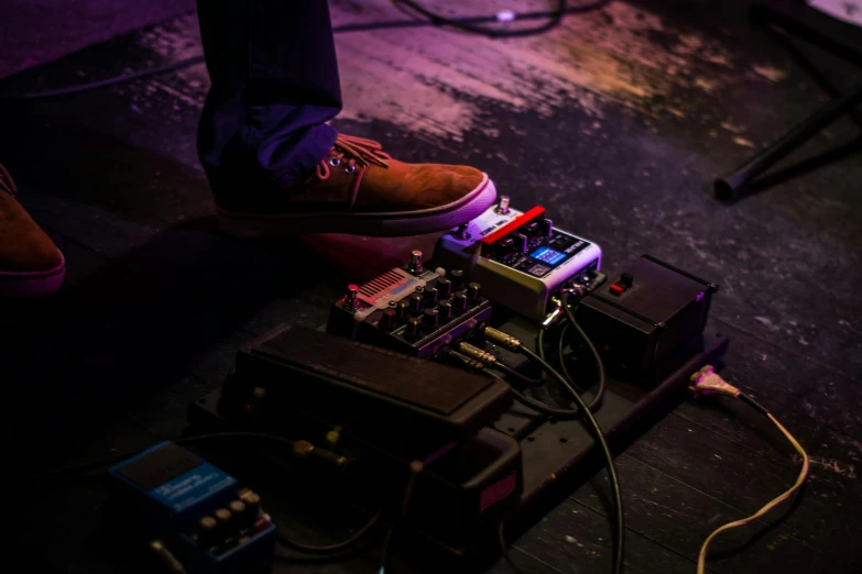 a close up of a person standing on a stage, by Tom Bonson, devices and instruments, detailed foot shot, ryan church, jamie reid