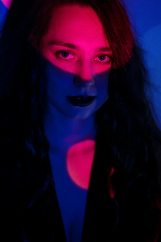 a woman with red and blue lights on her face, an album cover, pexels contest winner, complementary colors, phosphorescent, medium portrait top light, lilith