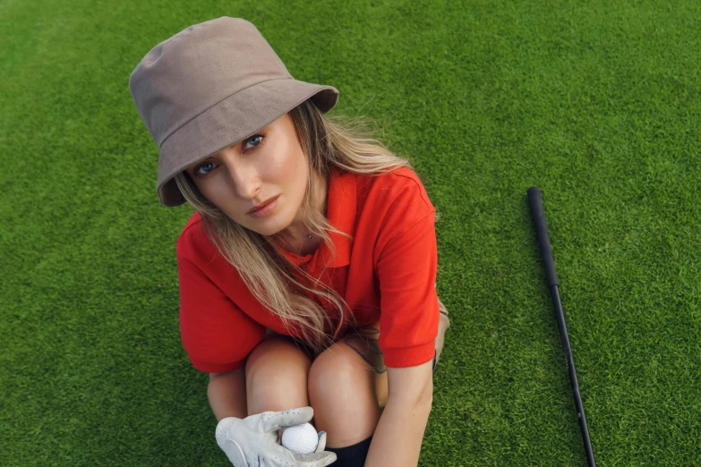 a woman kneeling on top of a green field holding a golf ball, a portrait, by Gavin Hamilton, trending on pexels, bucket hat, avatar image, blonde, anna nikonova aka newmilky