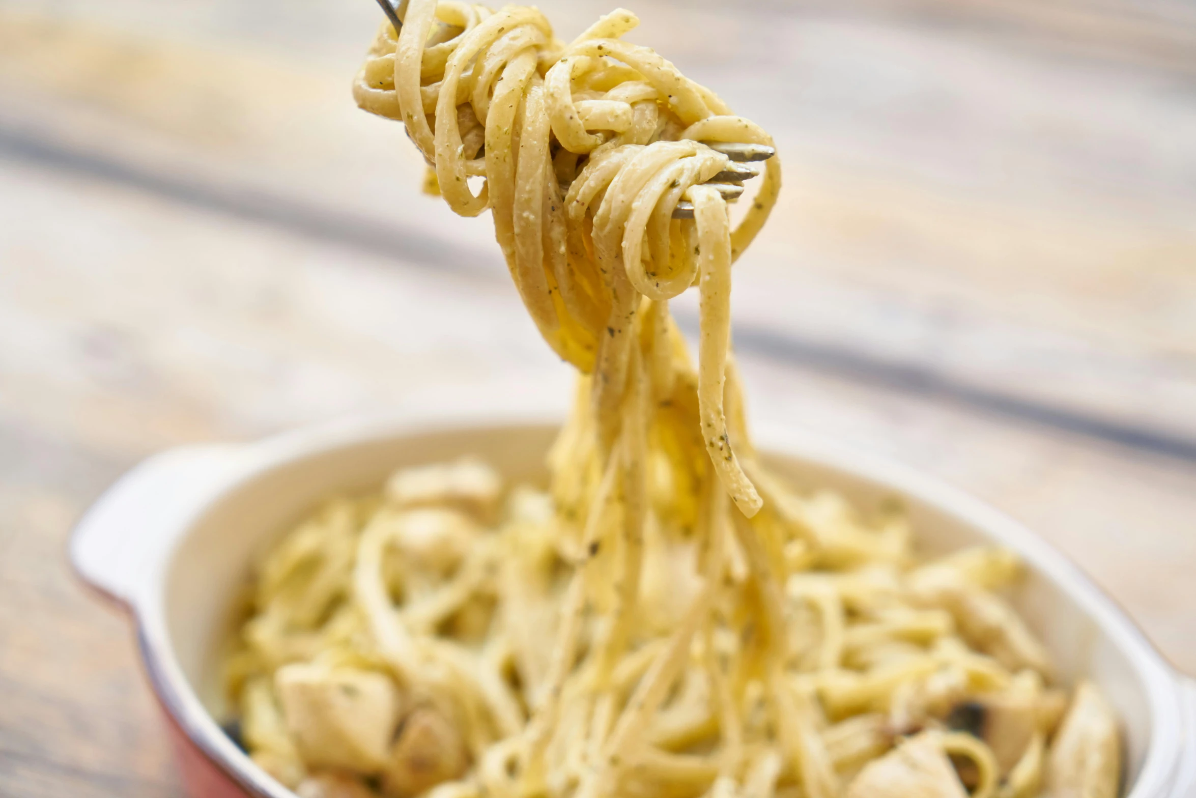 a close up of a bowl of pasta with a fork, hanging, chicken, filaments, zido