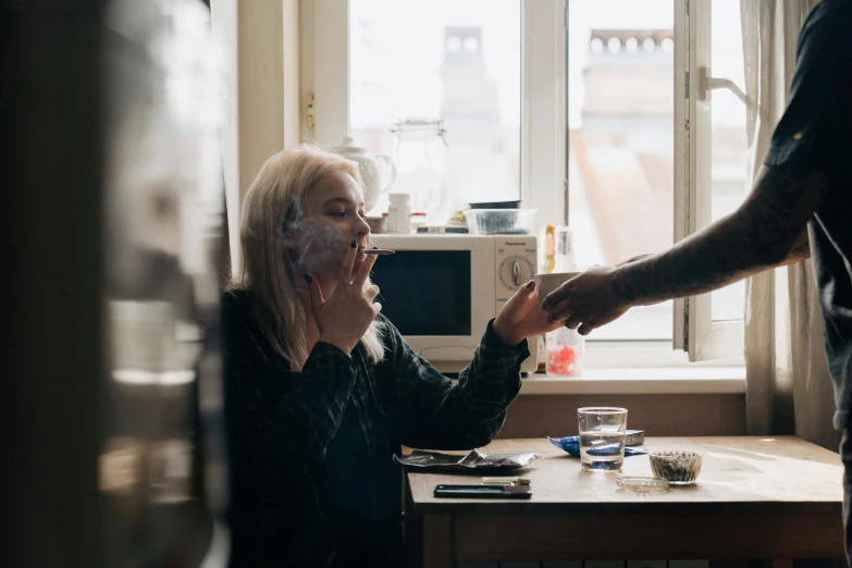 a couple of people that are sitting at a table, inspired by Elsa Bleda, pexels contest winner, hyperrealism, smoking a bowl of hash together, blonde swedish woman, at home, taking mind altering drugs