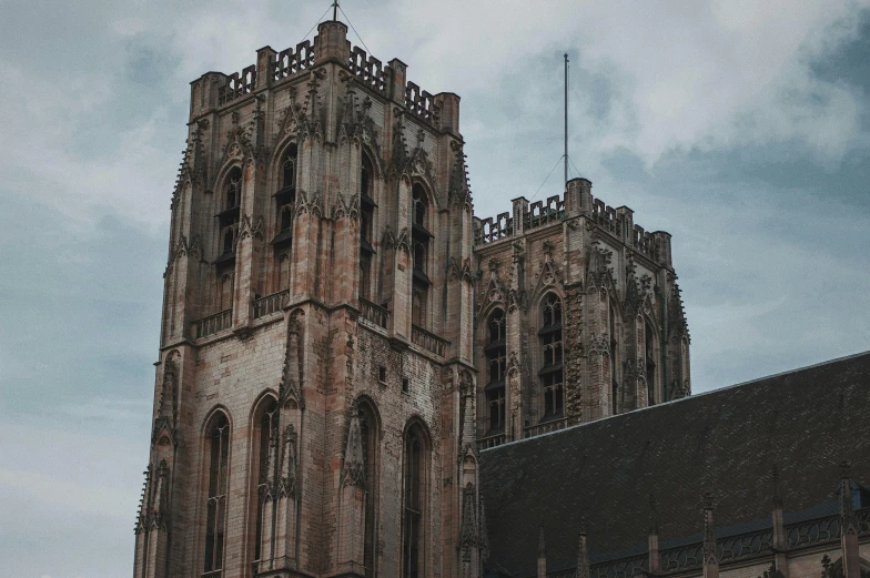 a tall building with a clock on top of it, by Jan Tengnagel, pexels contest winner, international gothic, utrecht, tall stone spires, dark gothic cathedral, well preserved