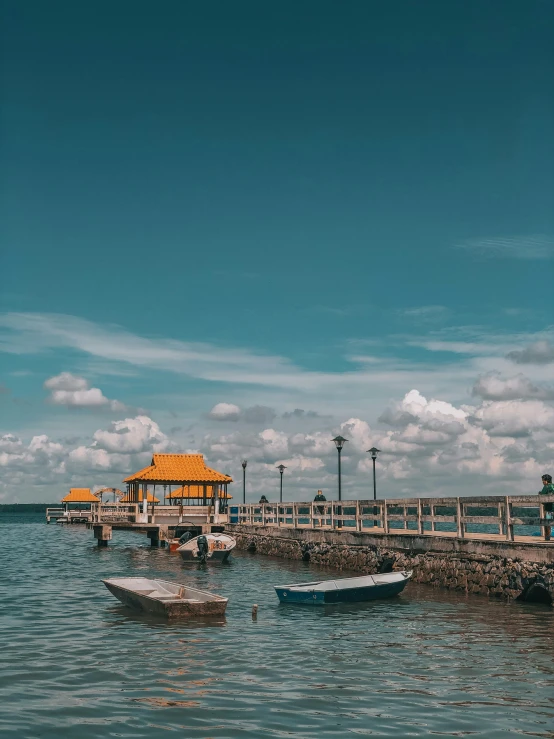 a couple of boats sitting on top of a body of water, happening, near a jetty, high-quality dslr photo”, philippines, movie set”