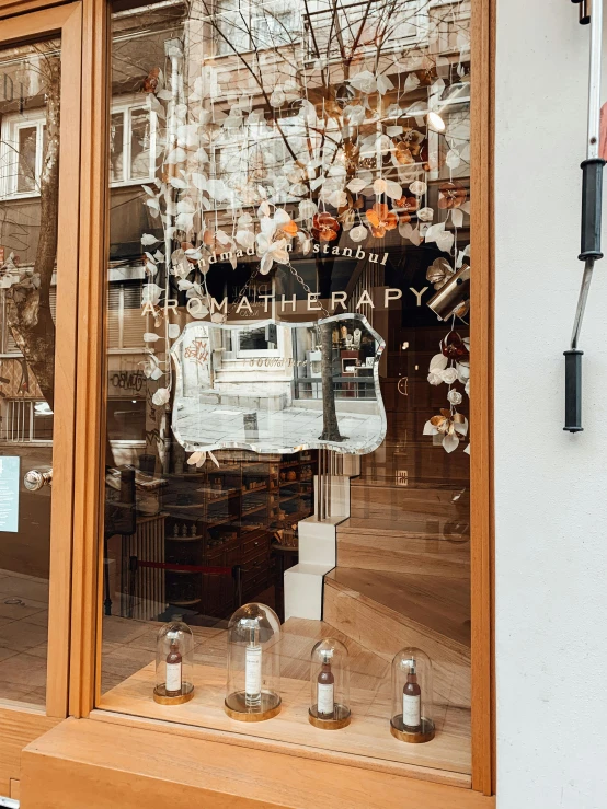 a woman sitting on a bench in front of a store, by Jacob Ochtervelt, trending on unsplash, art nouveau, glass helmets and dove wings, apothecary, an enormous silver tree, light coming from the entrance