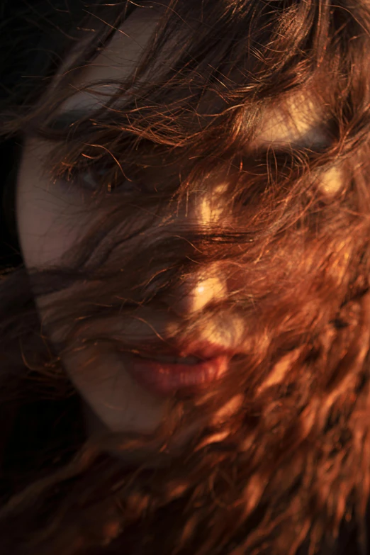 a woman with her hair blowing in the wind, an album cover, inspired by Elsa Bleda, trending on pexels, glowing crimson head, high angle closeup portrait, soft light 4k, evening sunlight