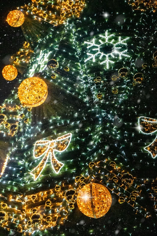 a close up of a christmas tree with lights, visual art, volumetric lighting from above, golden orbs and fireflies