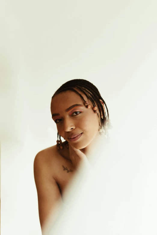 a woman standing in front of a mirror, an album cover, by Cosmo Alexander, trending on pexels, portrait androgynous girl, cornrows, bare shoulders, set against a white background