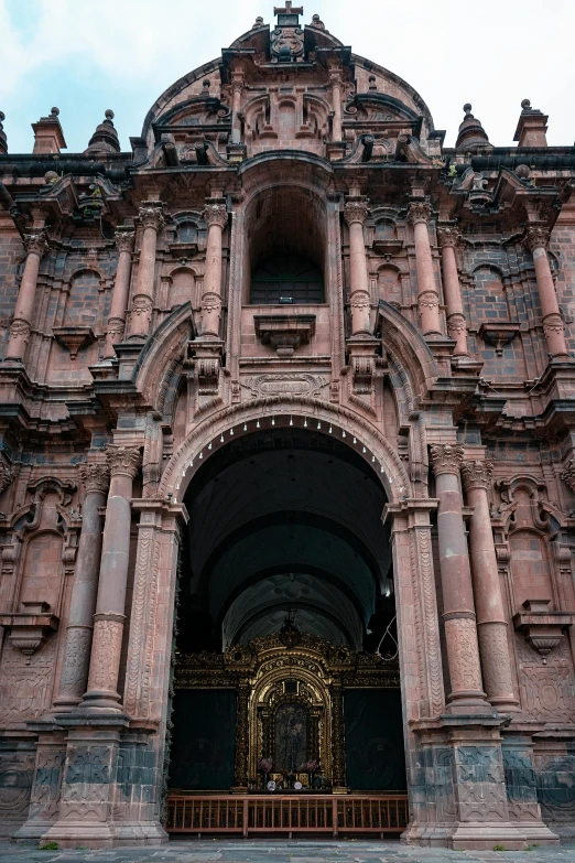 a large building with a statue in front of it, an album cover, pexels contest winner, quito school, intricate copper details, arch, 1 8 th century south america, terracotta