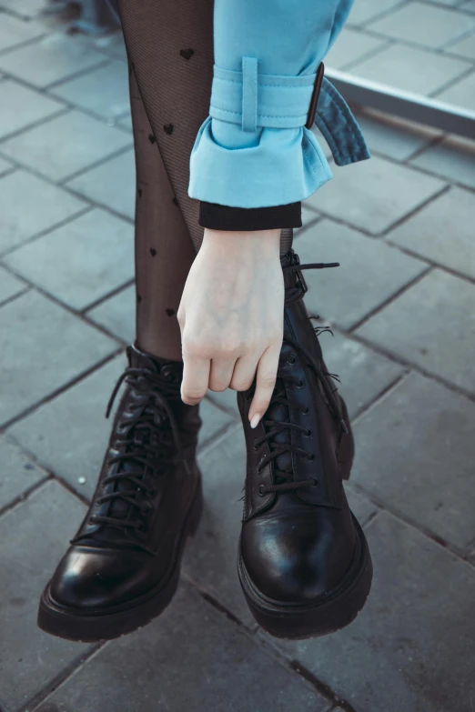 a close up of a person wearing black shoes, inspired by Elsa Bleda, outfit: cop, teenager girl, medium-shot, boots