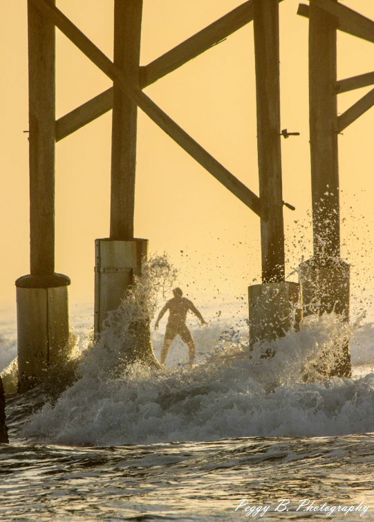 a man riding a wave on top of a surfboard, by Brad Holland, pexels contest winner, renaissance, near a jetty, golden hour in pismo california, national geographic ”, a wooden