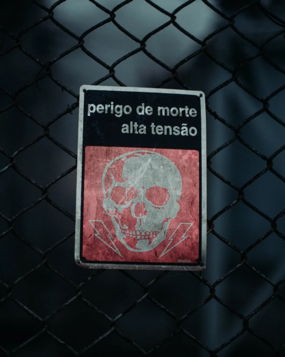 a close up of a sign on a fence, by Elsa Bleda, pexels contest winner, graffiti, skull on the chest, momento mori, nazare (portugal), poisonous