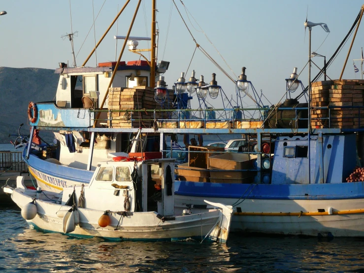 a couple of boats that are in the water, pexels contest winner, hurufiyya, fish seafood markets, avatar image, cyprus, profile pic