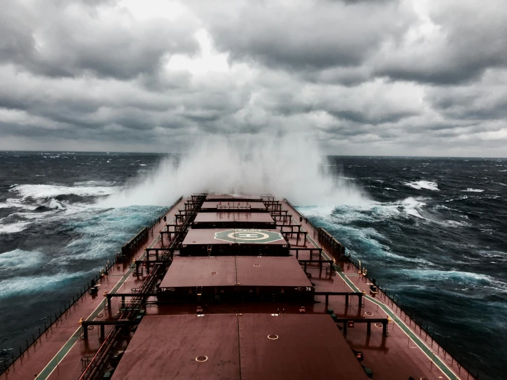 a large ship in the middle of the ocean, by Brad Holland, pexels contest winner, fantastic realism, stormy day, ocean spray, leading lines, bulky build