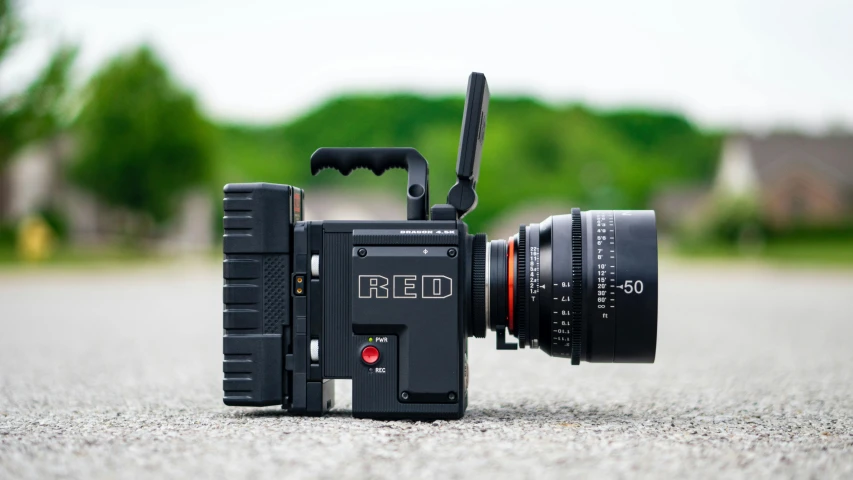 a camera that is sitting on the ground, by Adam Rex, unsplash, photorealism, red mechanical body, medium close - up ( mcu ), production ready, 4k press image