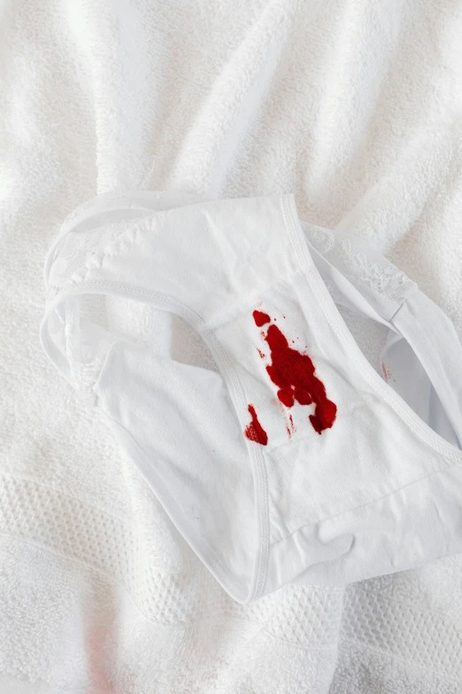 a white shirt with a blood stain on it, wearing white pajamas, multiple stories, holster, detail shot