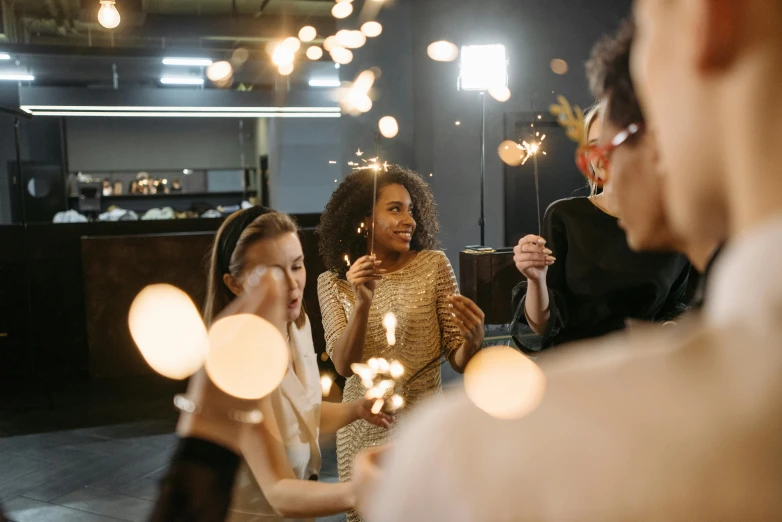 a group of people holding sparklers in their hands, pexels contest winner, happening, scene from a dinner party, people at work, varying ethnicities, wearing festive clothing