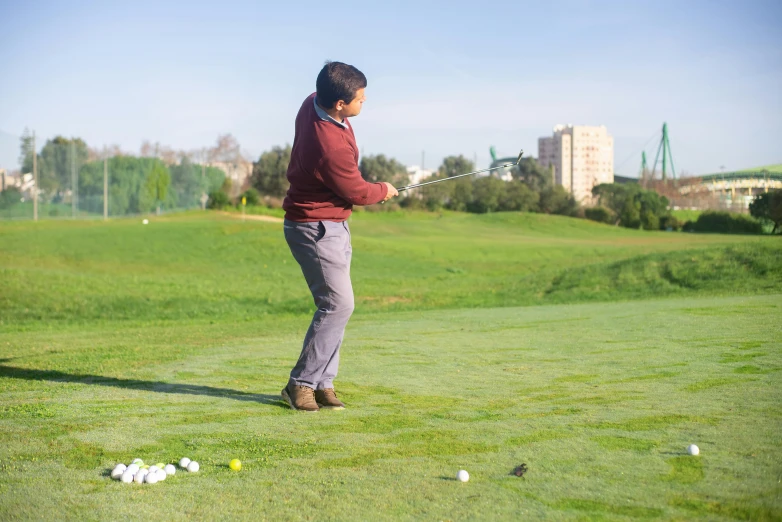 a man that is standing in the grass with a golf club, by Alejandro Obregón, pexels contest winner, mid action swing, chilean, 15081959 21121991 01012000 4k, city park